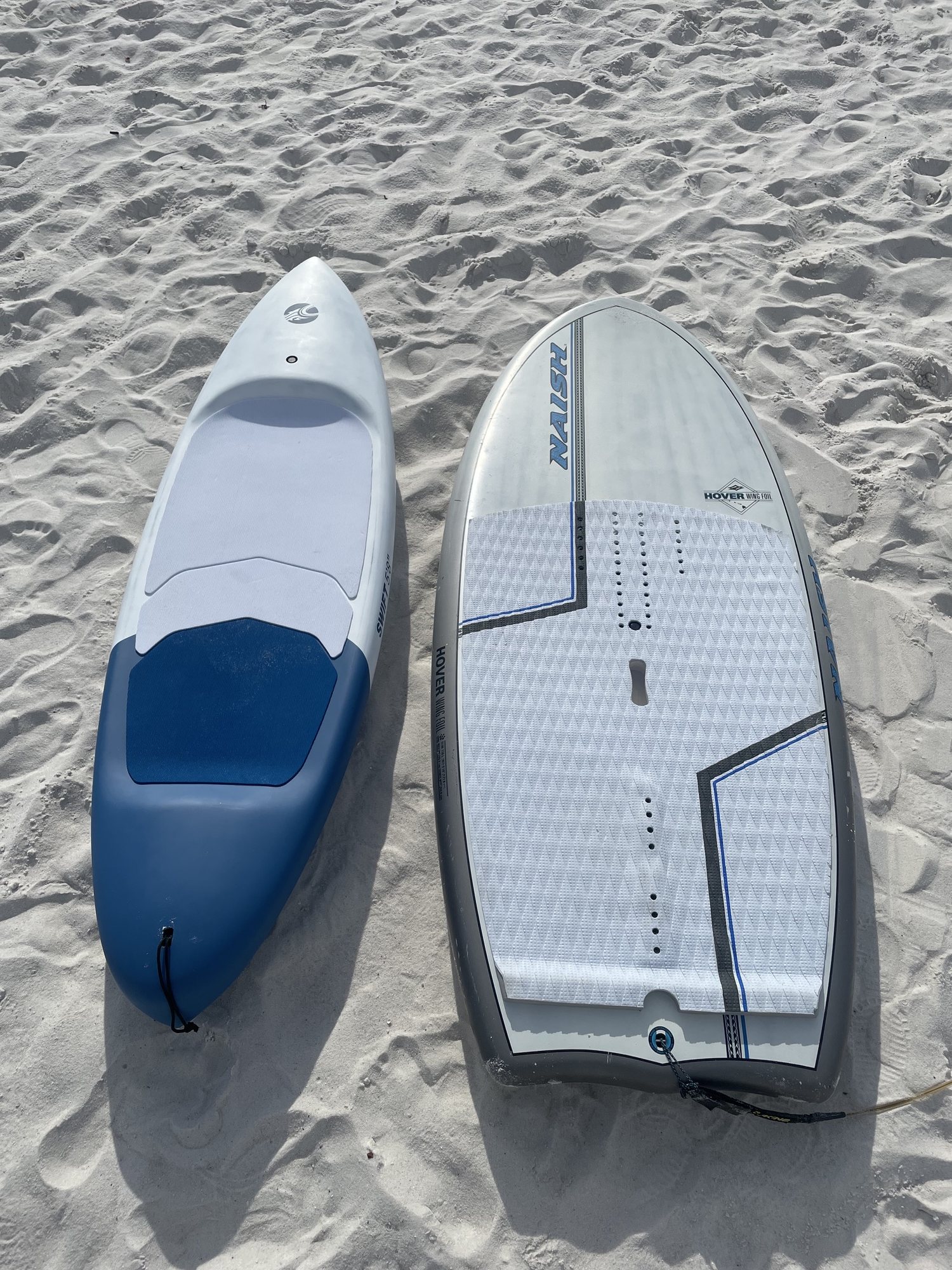 Naish Hover and Cabrinha Swift wing foil boards side by side